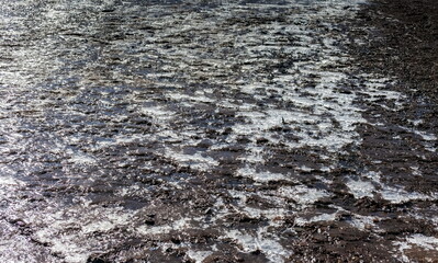 Ice, after the snow melts and freezes on the mountainside close-up in spring (Background, banner, Wallpaper)