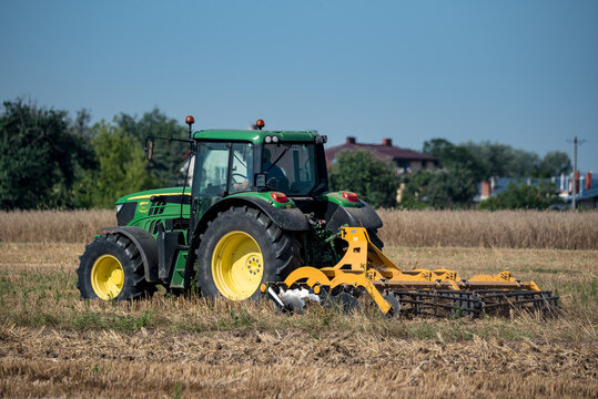 Serock, Poland - August 8, 2020: Work in the field after the harvest. Agricultural machinery and soil preparation for sowing. Season of summer work in the countryside.
