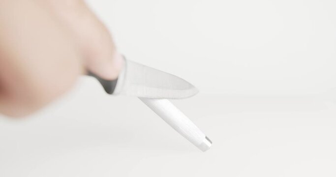 Close up chef handle sharpening knife on white background, prepare to cook food at kitchen restaurant,Tools for working in the kitchen.