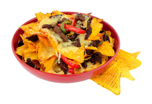 Bowl of beef and cheese nachos with red and green peppers isolated on a white background