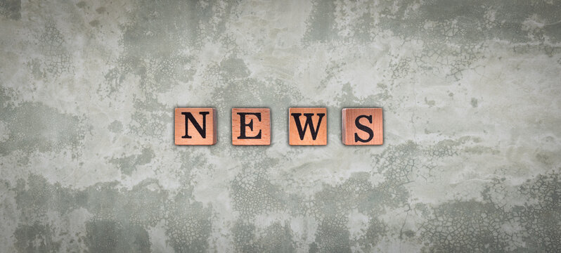 News word on wooden block alphabet cube. New normal after covid-19 pandemic with social distancing, good hygiene on cement wall