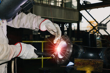 Closeup Welder is welding Tungsten Inert Gas welding with spark light, TIG weld for making new pipe...