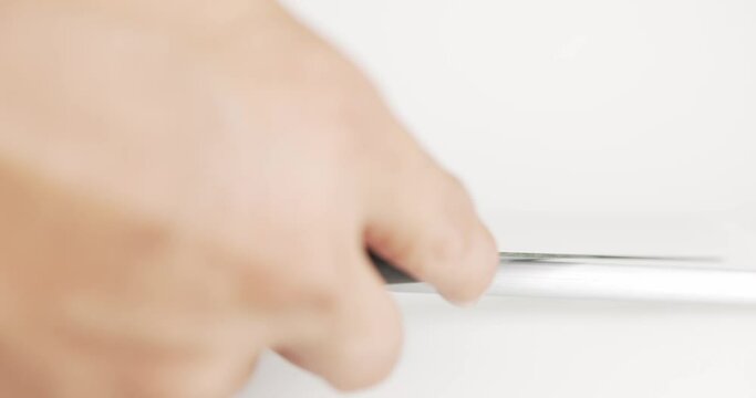 Close up chef handle sharpening knife on white background, prepare to cook food at kitchen restaurant,Tools for working in the kitchen.