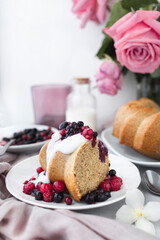 Delicious homemade cake with coconut yogurt cream and red berries. Healthy snack or breakfast. Luminous food photography
