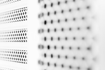 Horizontal ventilation grille. Air vents. Metal construction. Angle view. Black and white tones.