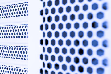 Horizontal ventilation grille. Air vents. Metal construction. Angle view. Black and white tones.