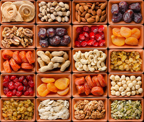 Seamless flat lay food background of dehydrated fruits, seeds and nuts on black. Non-perishable antioxidant gluten free foods concept