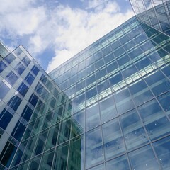 Fototapeta na wymiar Modern glass office buildings. Sky with clouds reflecting on the facade