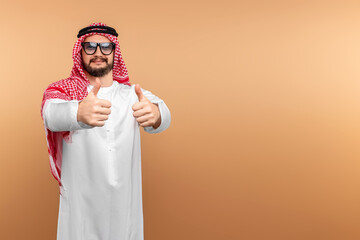 A Saudi Arab man in national dress and sunglasses. Dishdasha, kandora, thobe, islam. Copy space.