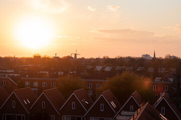 Sunset over a Dutch Vinex neighbourhood with a windmill in the distance