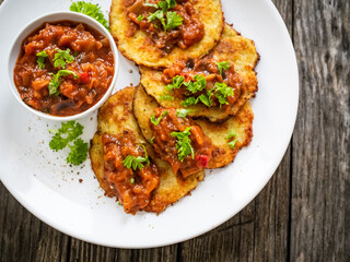 Potato pancakes with vegetable stew on wooden table