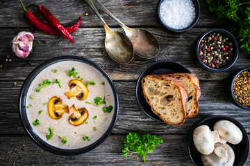 Cream of mushroom soup on wooden table
