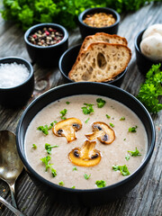 Cream of mushroom soup on wooden table
