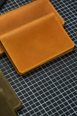 Set of handmade leather goods, key holder rings, wallet, purse, notepad, handbook. Handcrafted leather goods, close-up