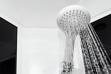Close-up of shower in the bathroom with pouring water.