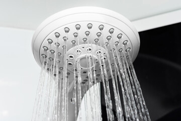Close-up of shower in the bathroom with pouring water.