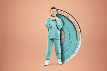 Fototapeta premium Portrait, cute stylish boy in a blue suit on a beige background. Studio portrait of a child, modern design, trendy background, turquoise. Copy space.