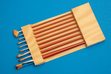 watercolor brushes on a blue background art colorful wood