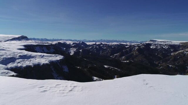 Mountain and snowy cliff on a sunny day
