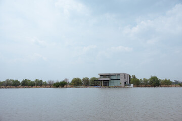 Fototapeta na wymiar rest house on the lake, cloudy day, calm water, summer vacation