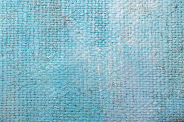 Rough canvas texture in blue tones of oil paint.