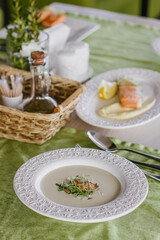 Cheese soup with salmon in green interior background