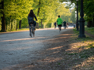 Woman Riding Her Bicycle in a Public City Park