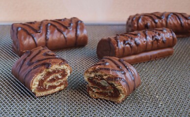 Small chocolate rolls on gray background 