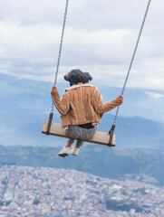 Young woman enjoying the largest swing in the world.