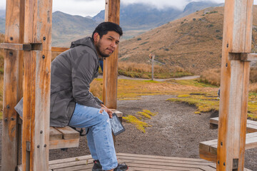 Young man enjoying the outdoors reading an electronic book.