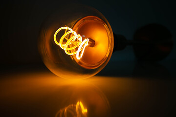 Orange Led shiny Bulb With Black Background and reflected light