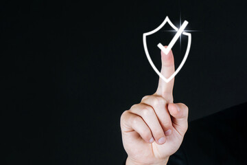 business man hand touching shield check mark icon virtual screen graphic diagram on dark background, internet security, innovation, network connection, investment and digital technology concept