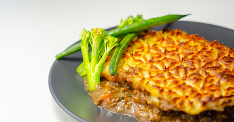 Tender minced lamb with garden veg in a hearty gravy beneath butter mash, typical Shepherd's pie