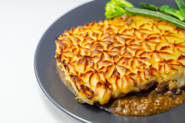 Tender minced lamb with garden veg in a hearty gravy beneath butter mash, typical Shepherd's pie