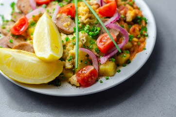 Haricot tomato bean sauce with turmeric potatoes, pork and herb sausage, and scrambled egg