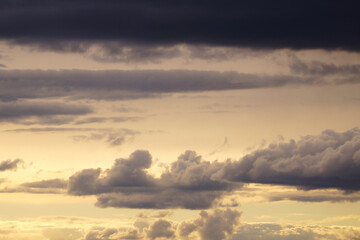 Fototapeta premium A sky with a variety of clouds, from light and white to dark thundercloud.