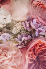 Blurred floral backdrop with pink filter, flowers over pastel colors with soft style for spring or summer time, with space for the text, suitable for a background.