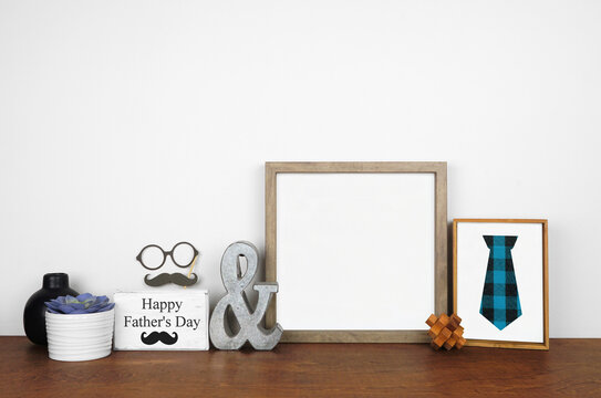 Mock up wood frame with rustic Fathers Day sign and decor. Wood shelf against a white wall. Copy space.