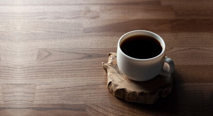 Cup of coffee on a wooden table. Breakfast. Empty table.