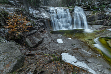 Fototapeta na wymiar Cold morning with Mumlavske waterfalls near Harrachov town in Krkonose mountains