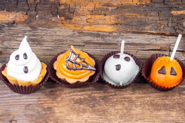 Set of Halloween sweets on old wooden background