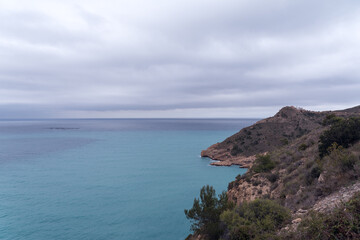 Fototapeta na wymiar Panoramic view of the Mediterranean coastline, the Mediterranean Sea, a lighthouse and a fish farm.