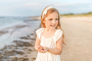 Smiling little girl at the seaside. Summer holidays concept.
