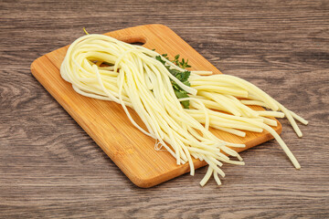 Chechil spaghetti cheese over board