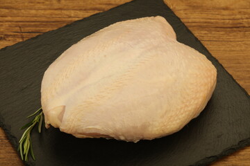 Raw whole chicken breast with skin