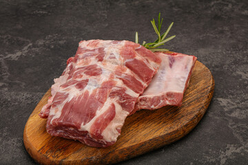 Raw pork ribs served rosemary
