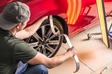 Removing dents on the car. PDR technology. Car body repair without painting. - obrazy, fototapety, plakaty