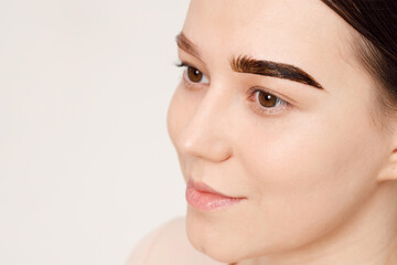 Make-up artist makes markings with pencil for eyebrow and paints eyebrows. Professional makeup and facial care. Styling, lamination, tweezing of eyebrows.