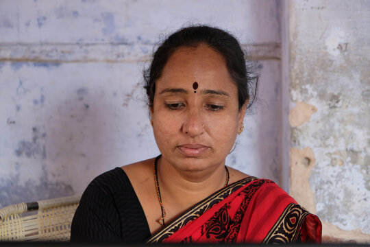 Closeup portrait of a sad tired Indian female looking down