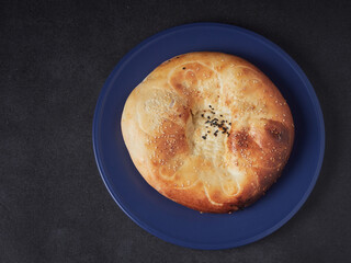 Traditional bread in Central Asia. Tandoor flatbread. Bread cakes. Traditional Uzbek the pellets.
